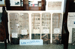Wooden grave markers displayed in Virginia City museum.