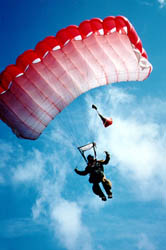 Smokejumper parachuting down.